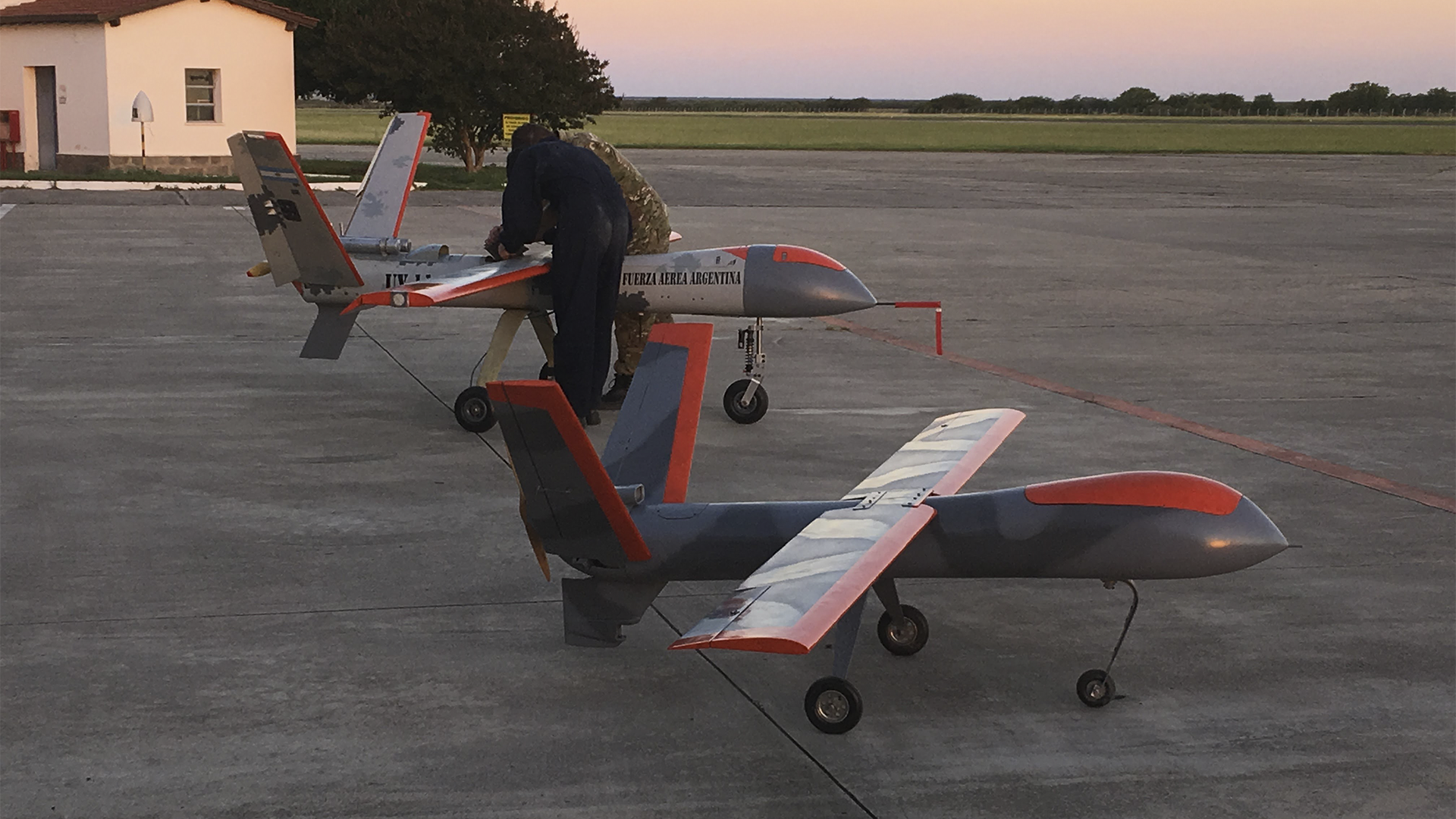 Technicians prepare Vigia 2 MALE UAVs for Argentinian Air Force missions at sunset.