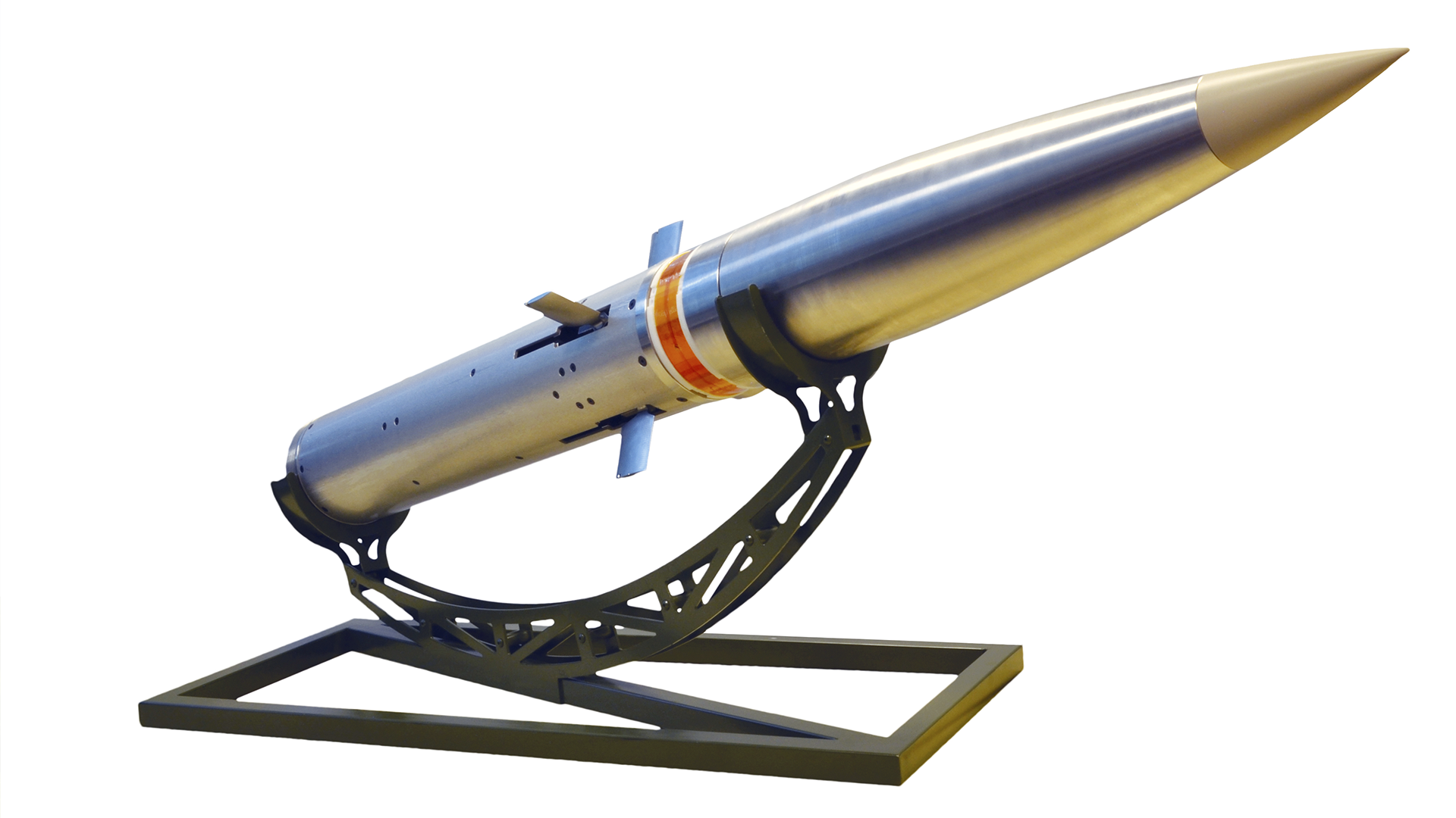 Close-up of a precision-guided missile displayed on a stand, showcasing its metallic body and aerodynamic design.