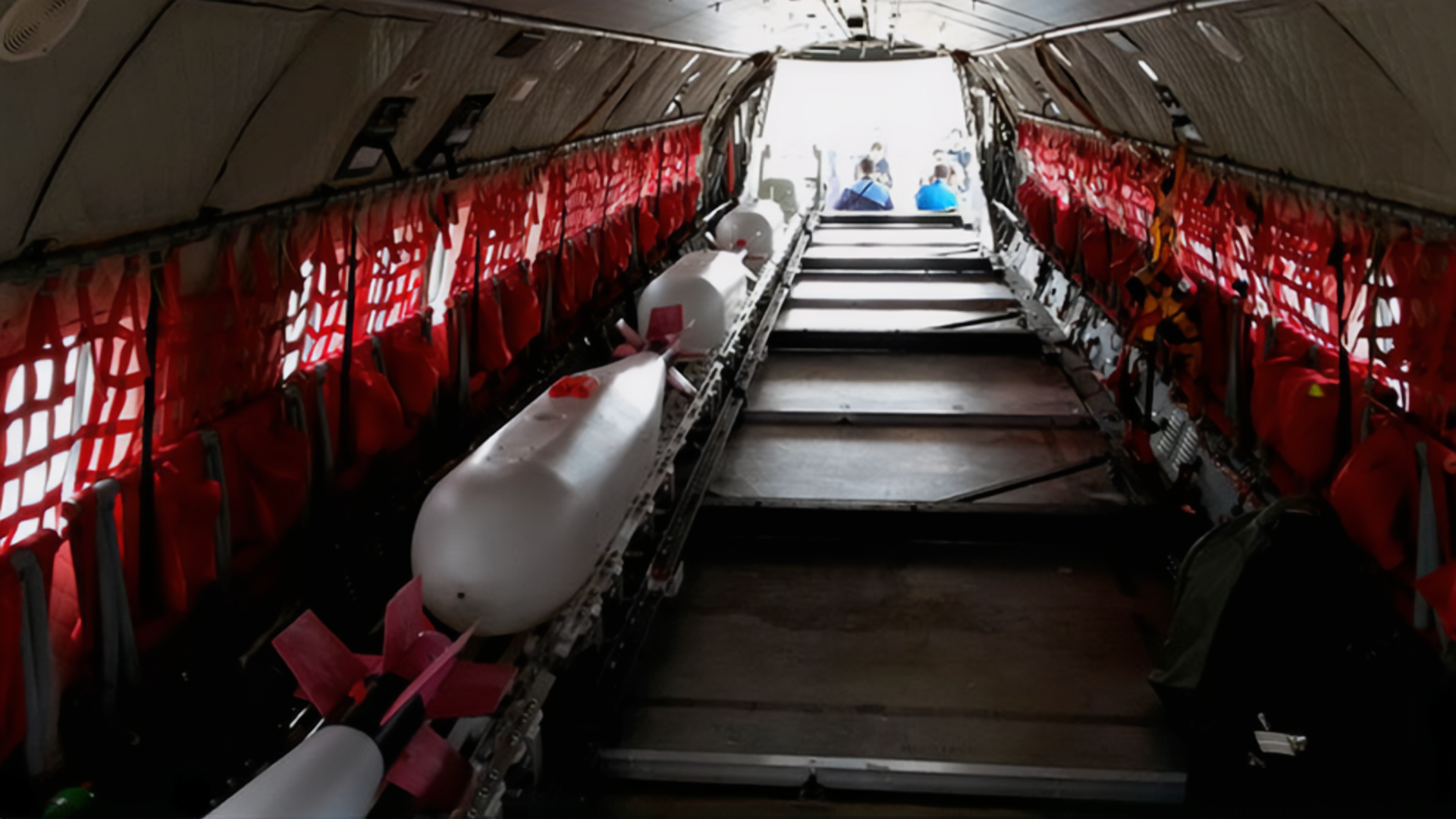 Interior of a cargo aircraft showing multiple drones loaded and secured for aerial firefighting missions.